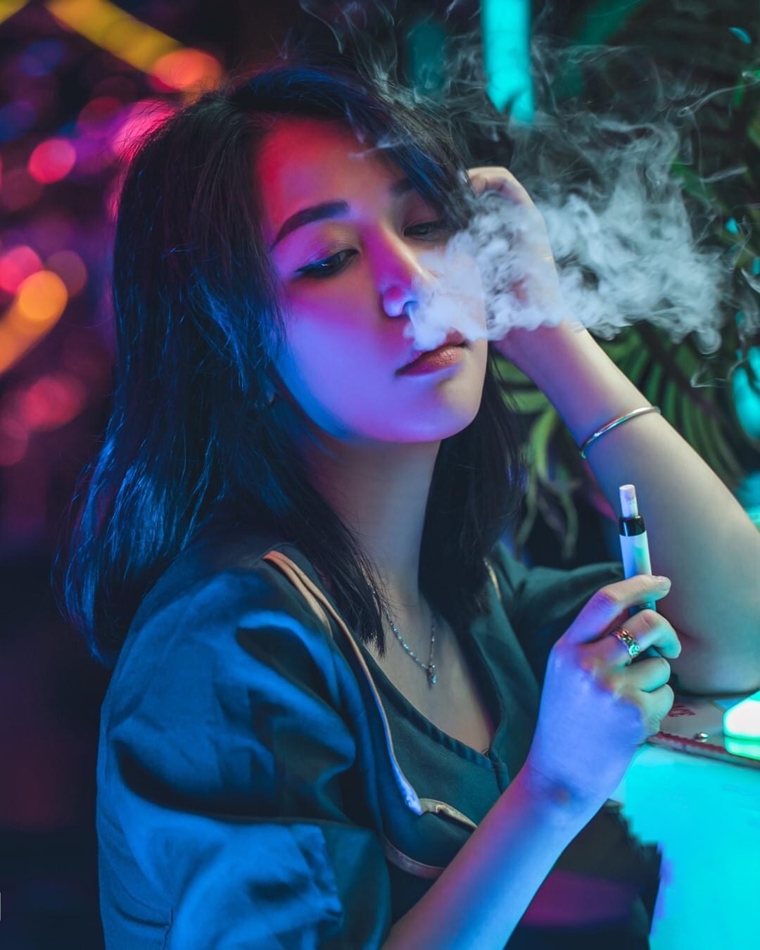 Hình ảnh cô gái hút vape, che mặt, trông rất ưa nhìn;